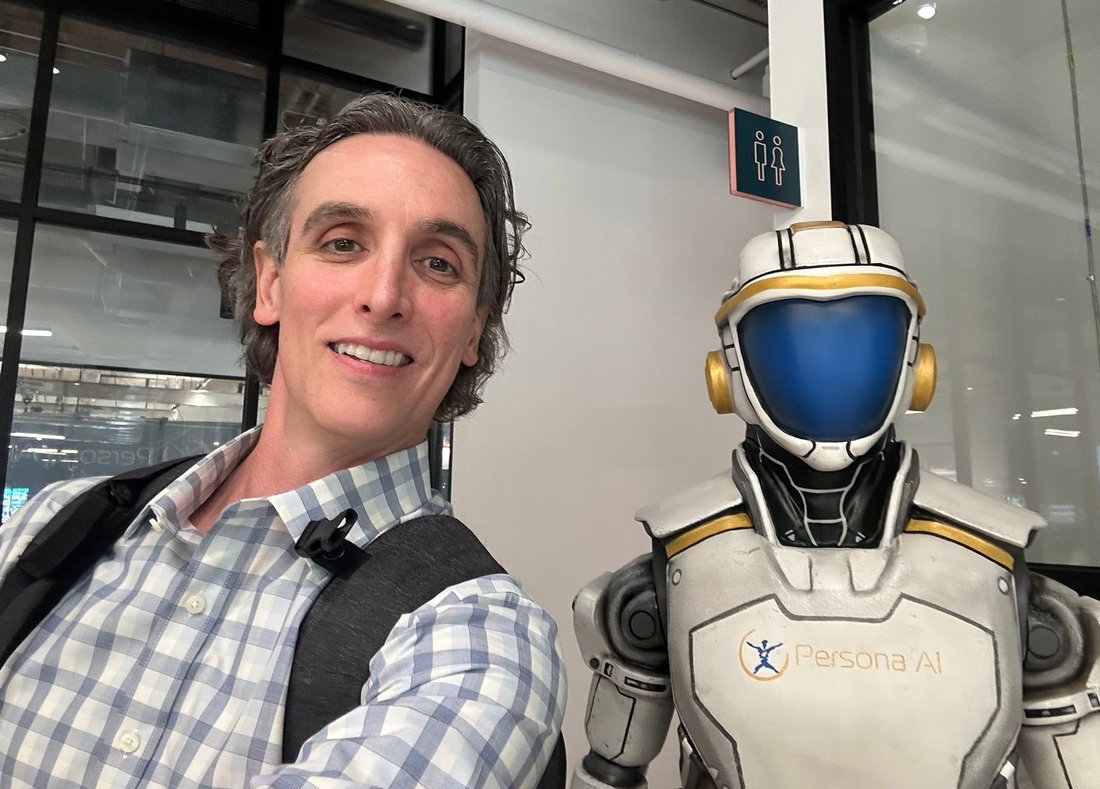 Matthew Bertram with the Persona AI humanoid robot - oil & gas AI keynote speaker